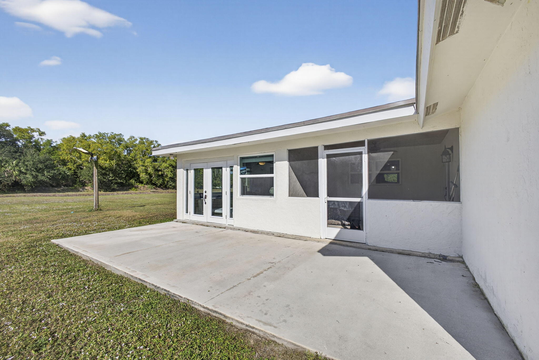 16490 Rustic Road Wellington, FL 33470 - Photo 50 of 81 a view of house with backyard and glass windows