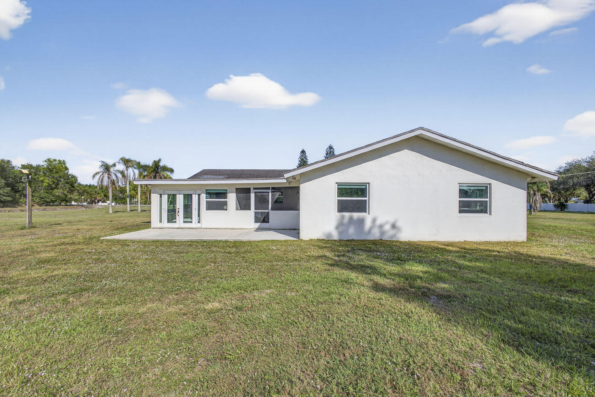 16490 Rustic Road Wellington, FL 33470 - Photo 52 of 81 a view of a house with a yard
