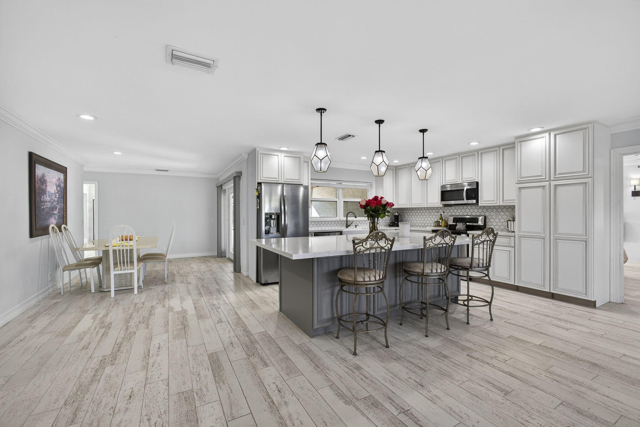 16490 Rustic Road Wellington, FL 33470 - Photo 6 of 81 a view of a dining room with furniture and wooden floor