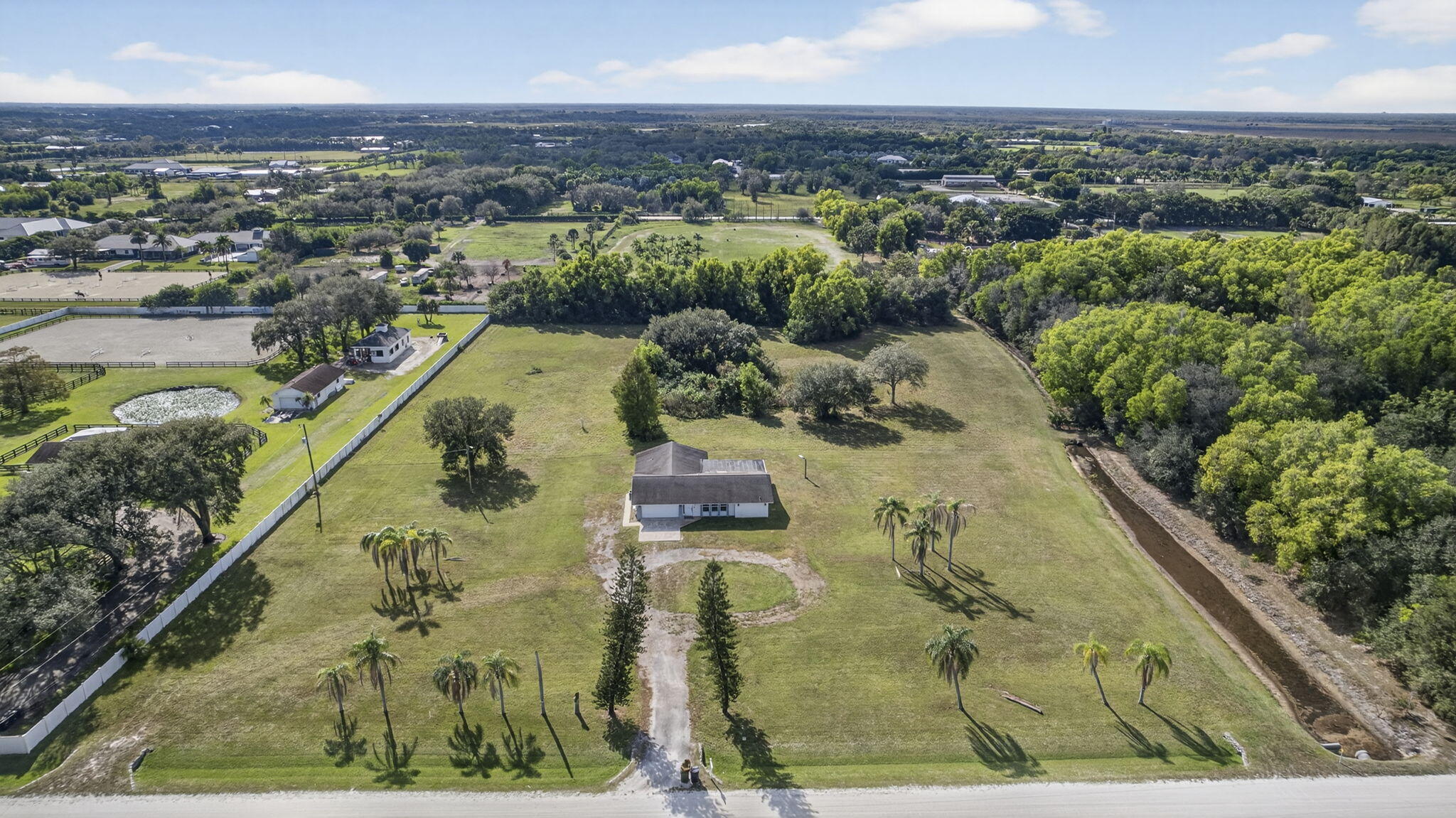 16490 Rustic Road Wellington, FL 33470 - Photo 61 of 81 an aerial view of a house with a yard