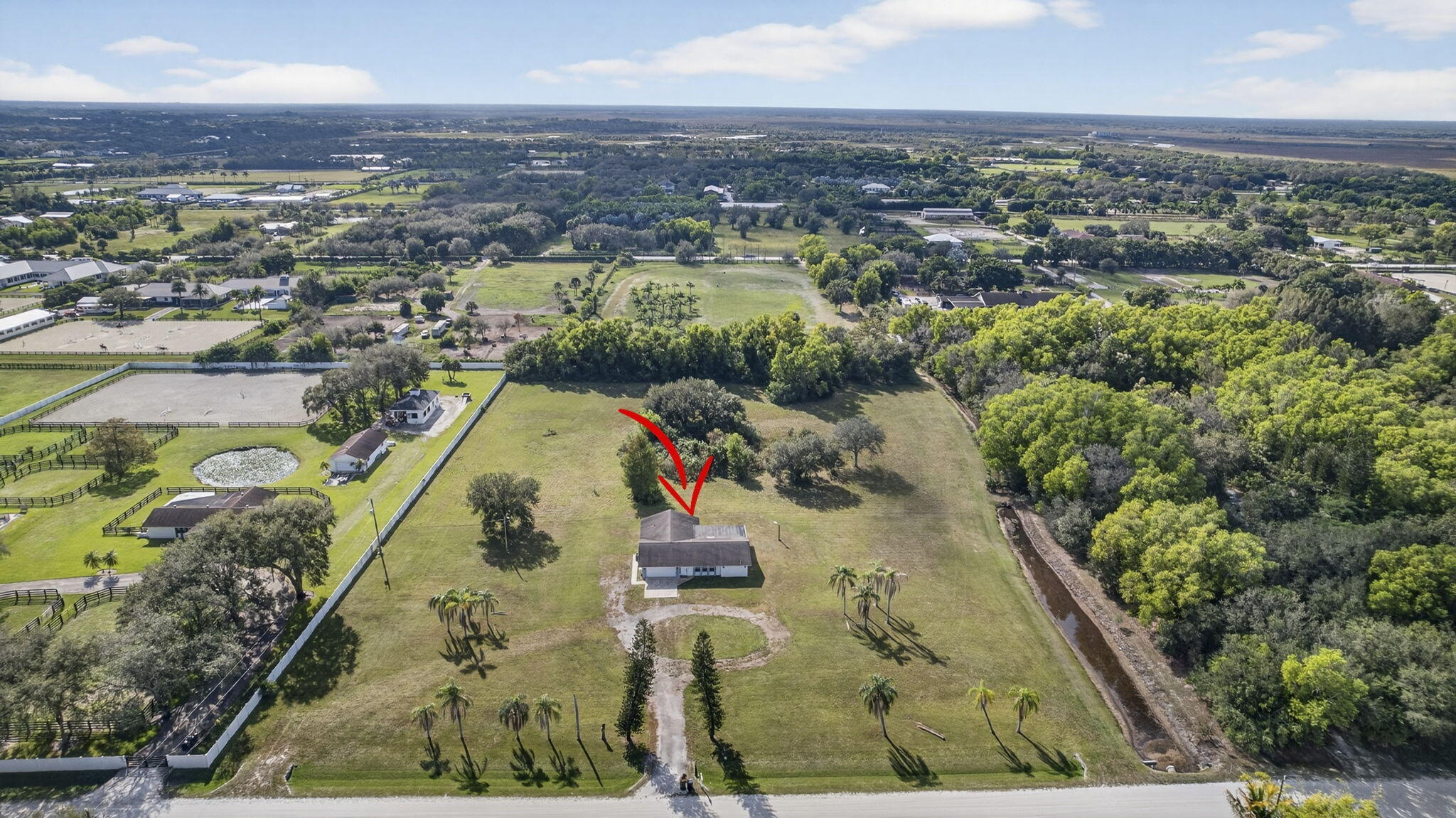 16490 Rustic Road Wellington, FL 33470 - Photo 62 of 81 an aerial view of residential houses with outdoor space