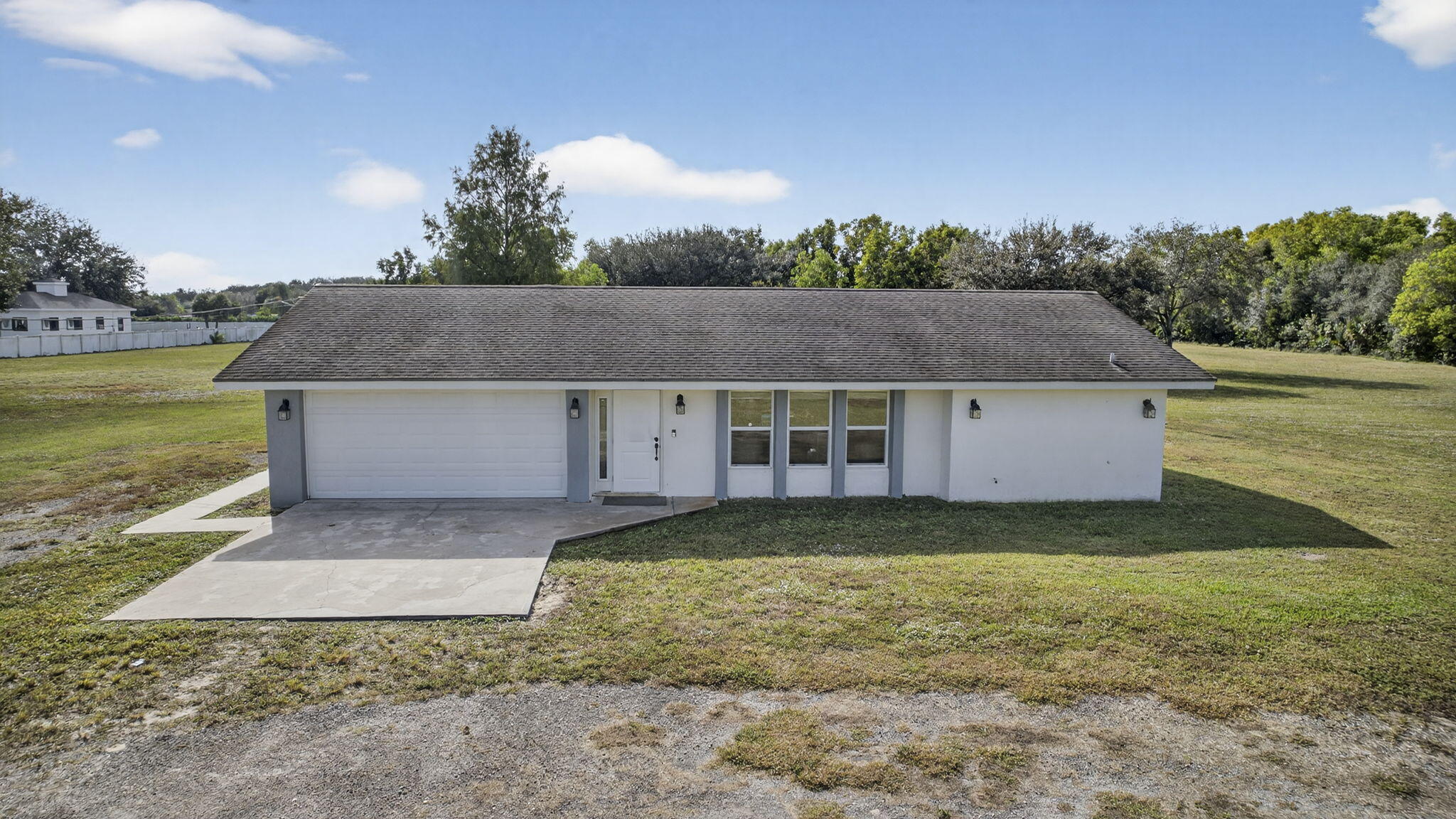 16490 Rustic Road Wellington, FL 33470 - Photo 69 of 81 a view of a house with a yard