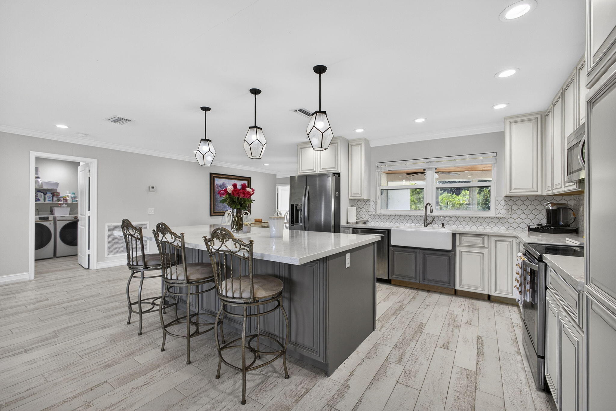 16490 Rustic Road Wellington, FL 33470 - Photo 8 of 81 a view of a kitchen and dining table with chairs