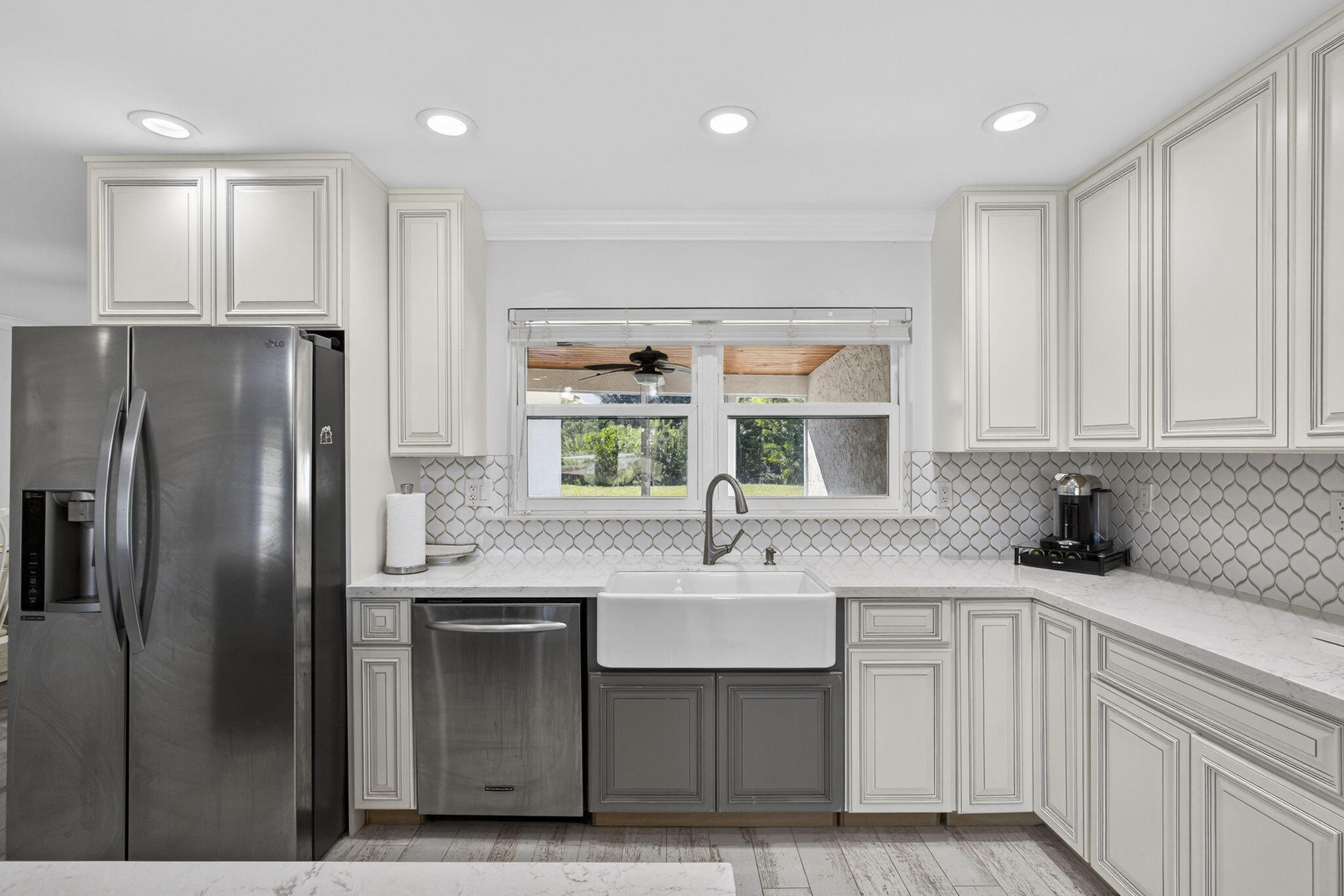16490 Rustic Road Wellington, FL 33470 - Photo 9 of 81 a kitchen with stainless steel appliances granite countertop a sink a refrigerator and a granite counter tops