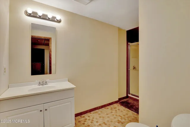 a picture of a bathroom with a sink and a mirror