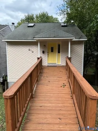a view of a house with wooden deck