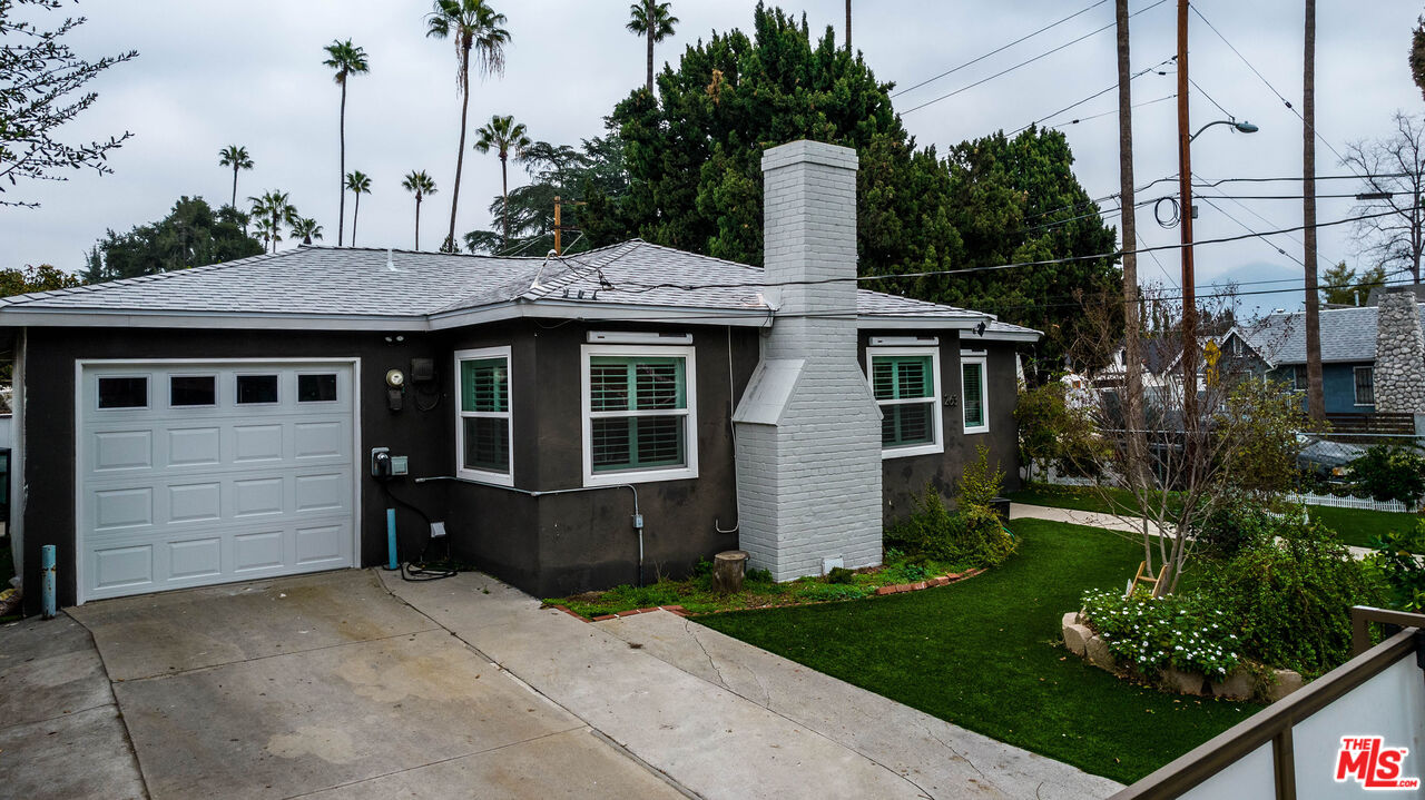 263 Flower Street Pasadena, CA 91104 - Photo 33 of 34 a front view of a house with a garden and plants