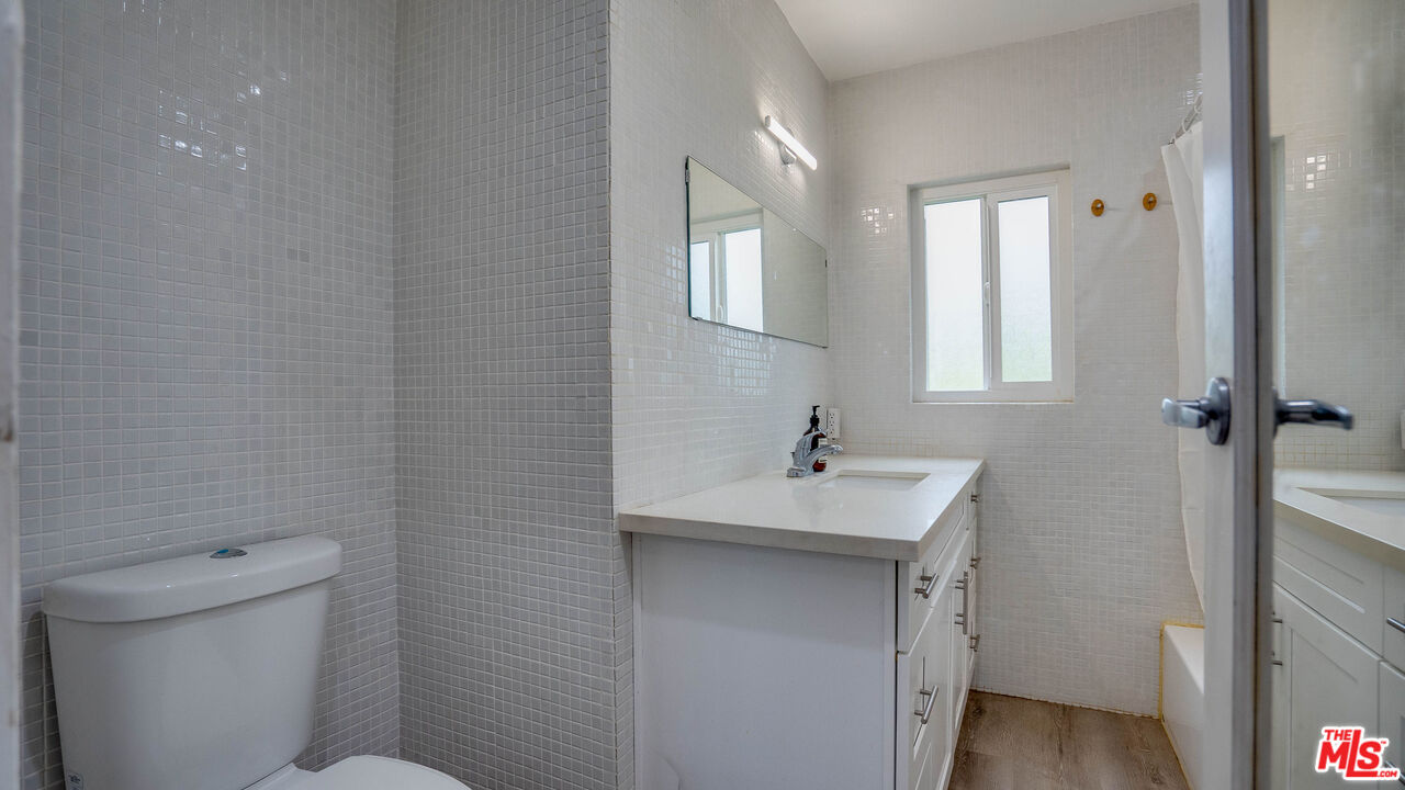 263 Flower Street Pasadena, CA 91104 - Photo 9 of 34 a bathroom with a sink toilet and vanity
