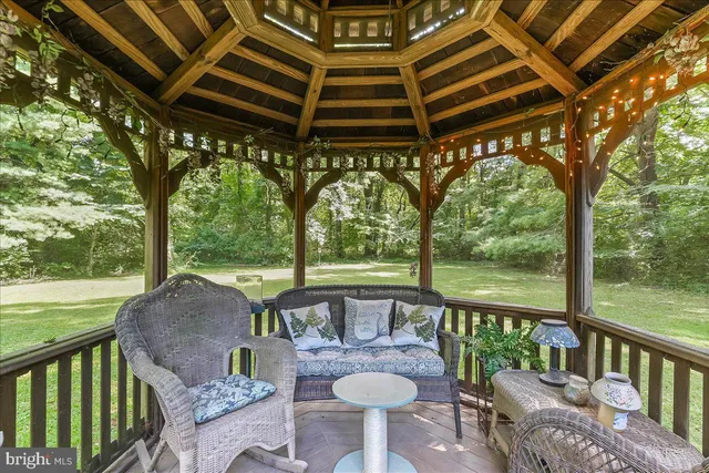 a view of a patio with a table chairs and a swimming pool