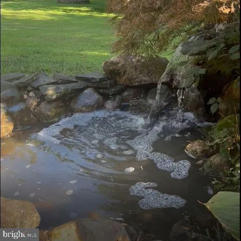 an aerial view of a house with a yard and trees