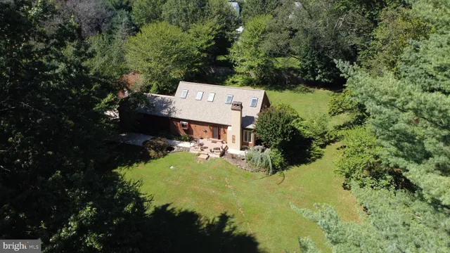 an aerial view of a house with swimming pool outdoor seating and yard