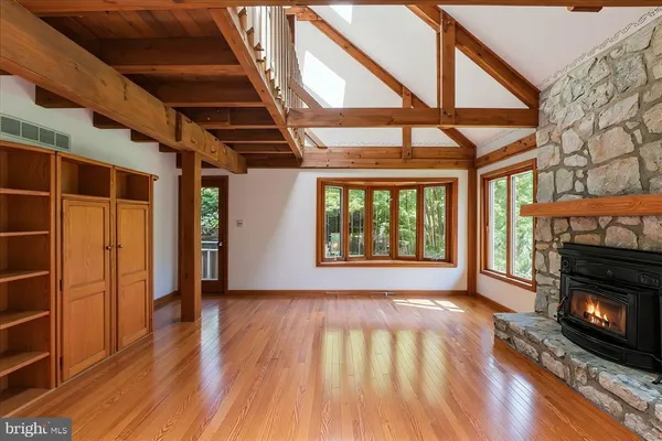 a dining room with furniture a chandelier and wooden floor