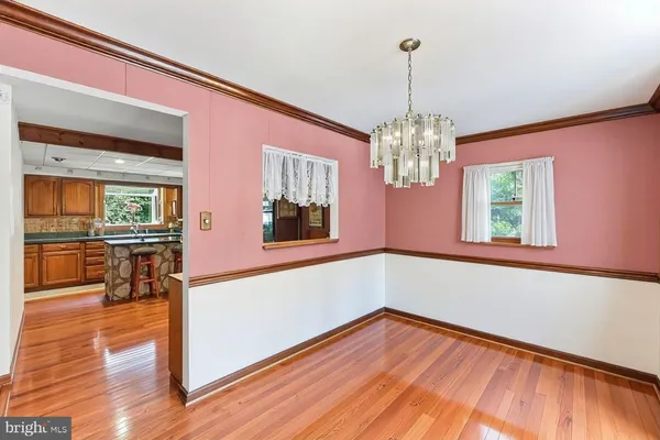 a view of a room with wooden floor and windows