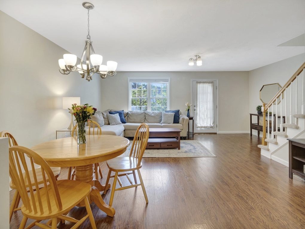 13 Shawmut Avenue, Unit 13 Mansfield, MA 02048 - Photo 4 of 34 a view of a dining room with furniture wooden floor and chandelier