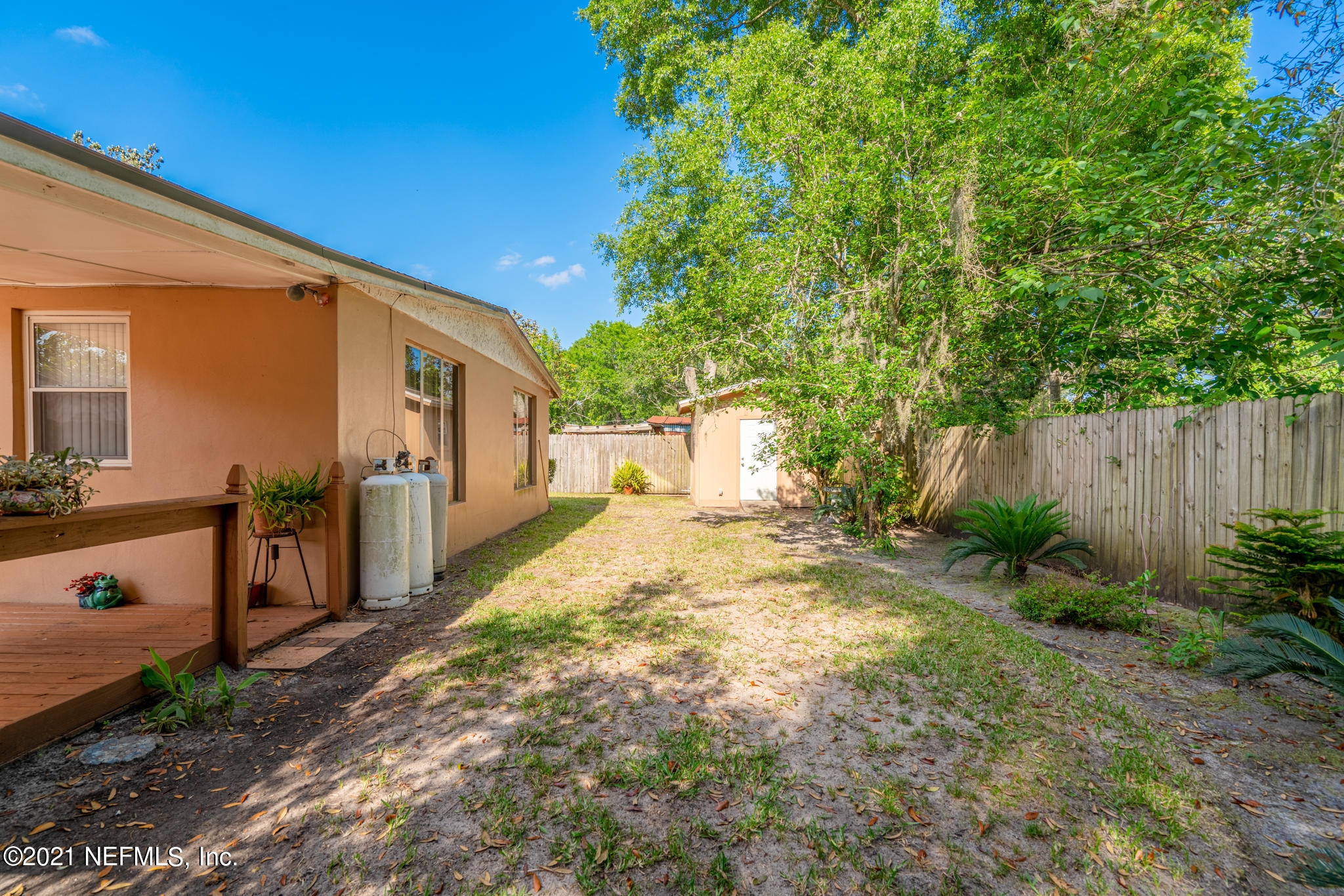 4612 Castleton Drive Jacksonville, FL 32208 - Photo 12 of 41 a view of a backyard with large trees and plants
