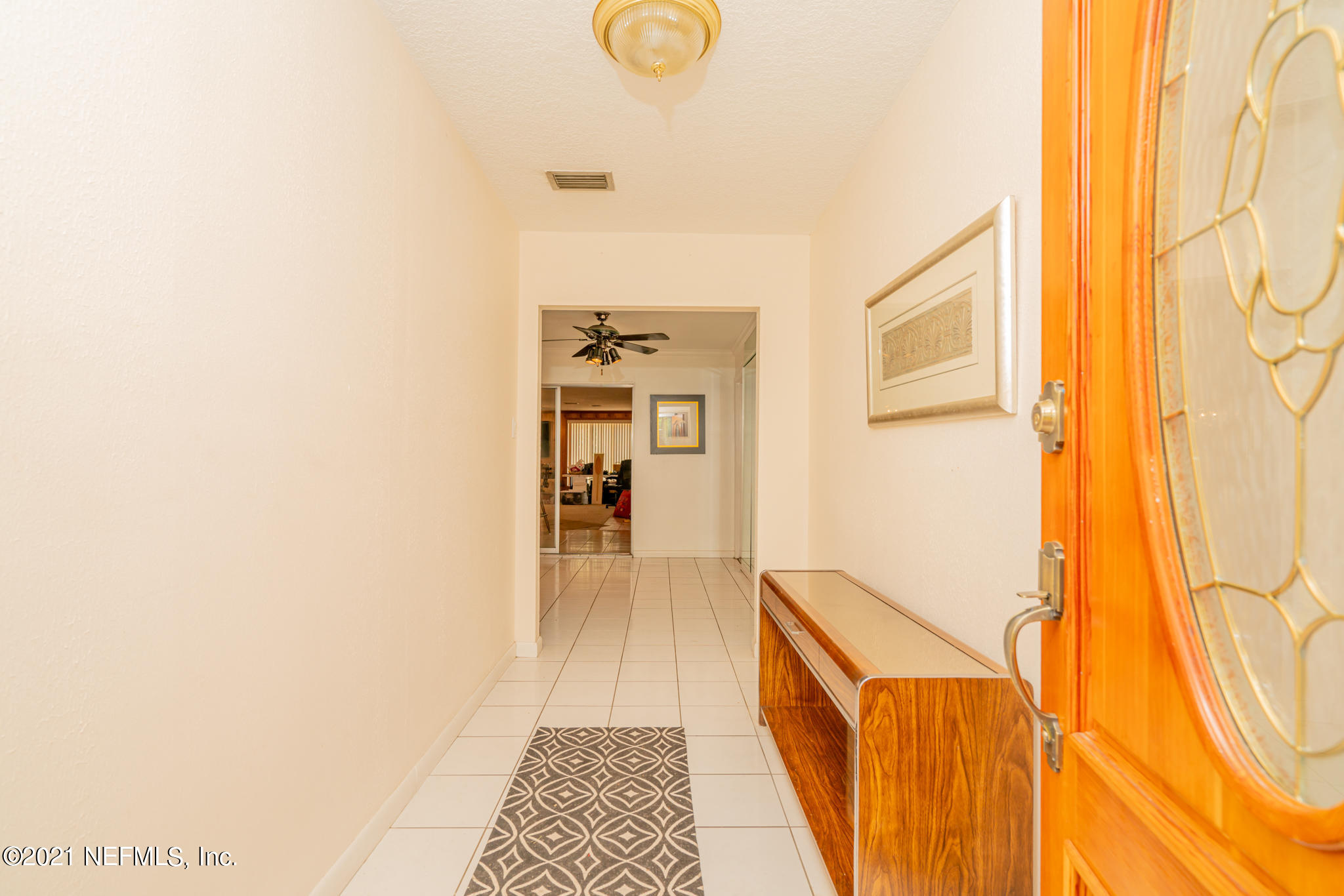 4612 Castleton Drive Jacksonville, FL 32208 - Photo 17 of 41 a hallway with sliding door and wooden floor