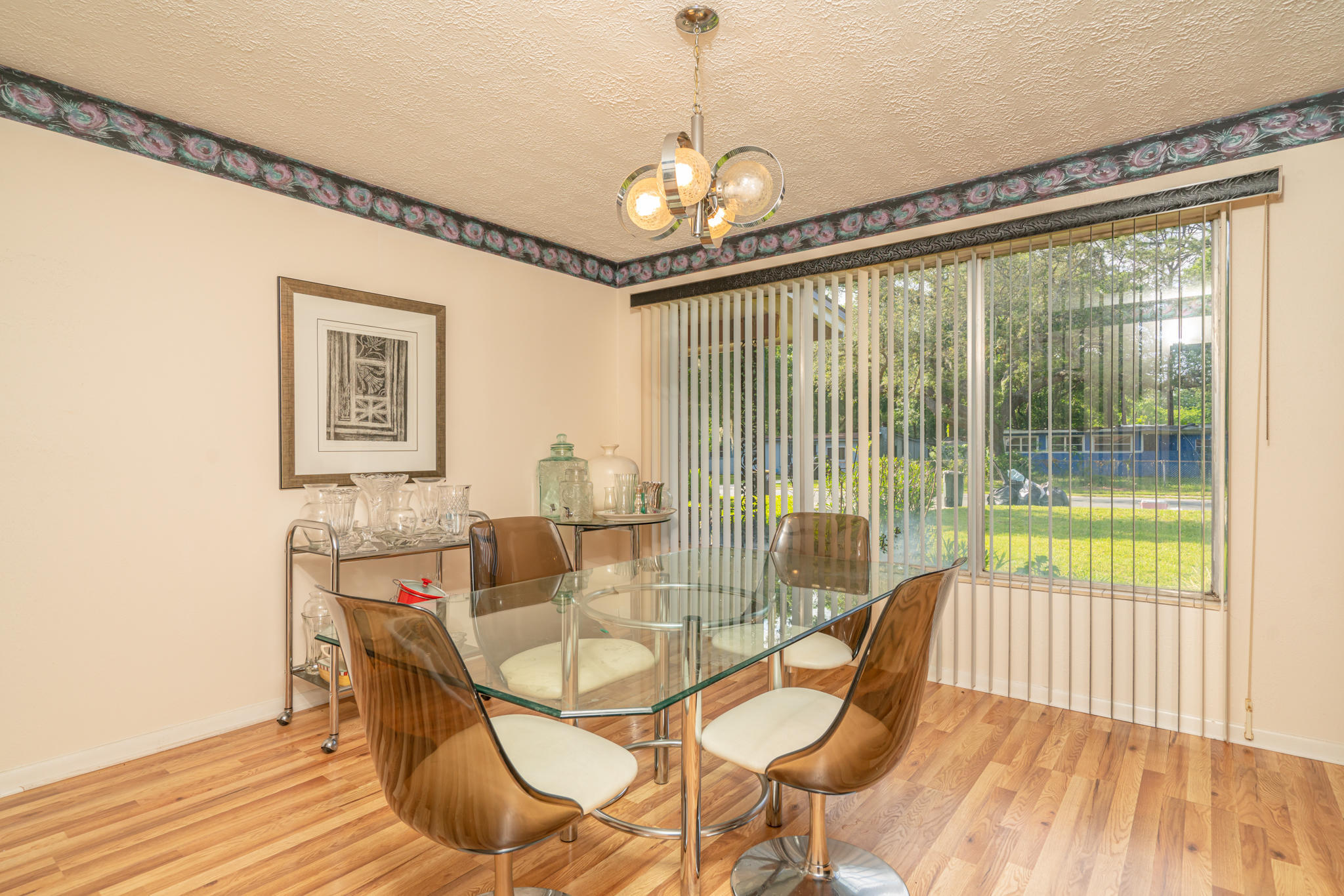 4612 Castleton Drive Jacksonville, FL 32208 - Photo 20 of 41 a dining room with furniture a chandelier and wooden floor
