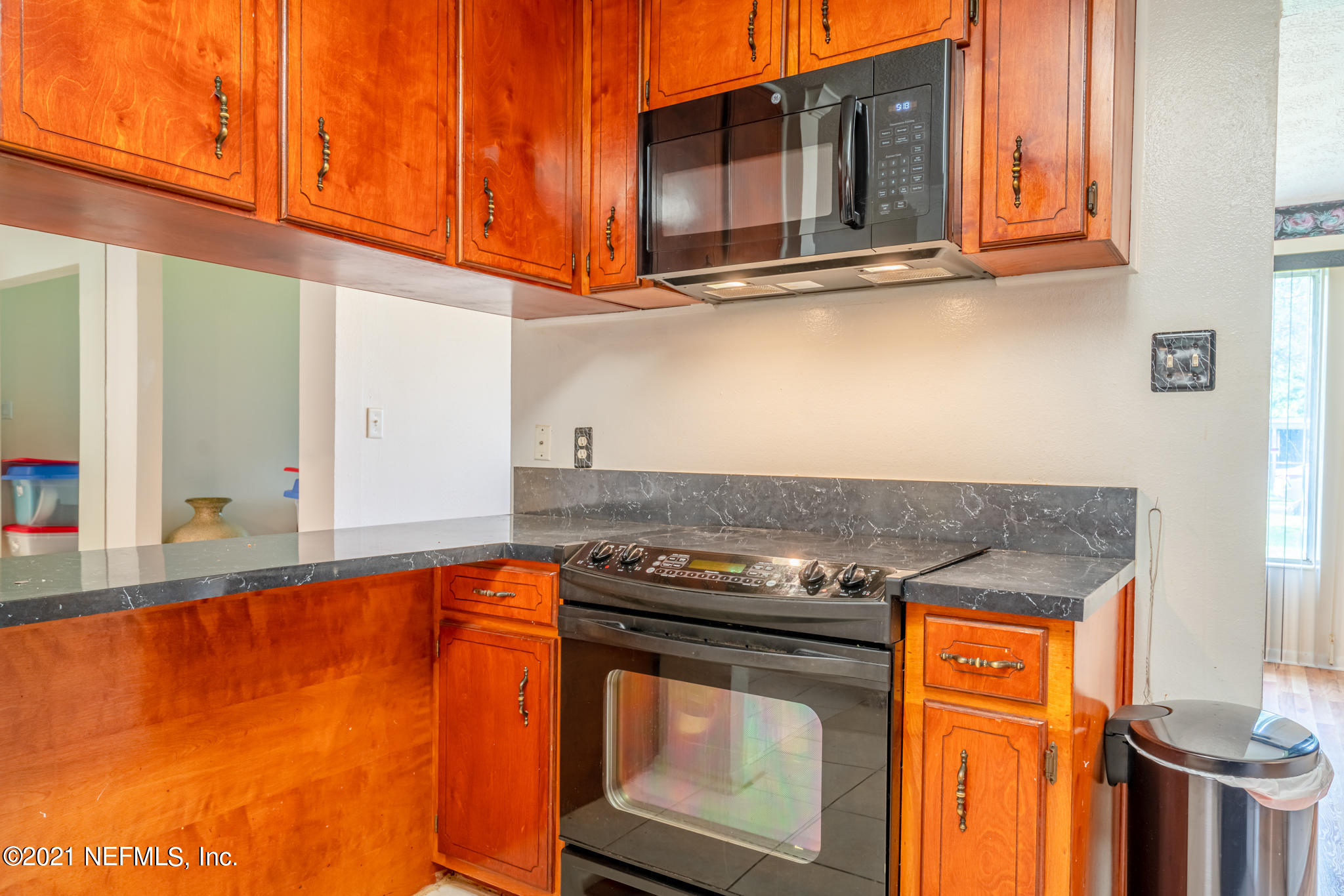 4612 Castleton Drive Jacksonville, FL 32208 - Photo 23 of 41 a kitchen with stainless steel appliances granite countertop a stove a sink and a microwave