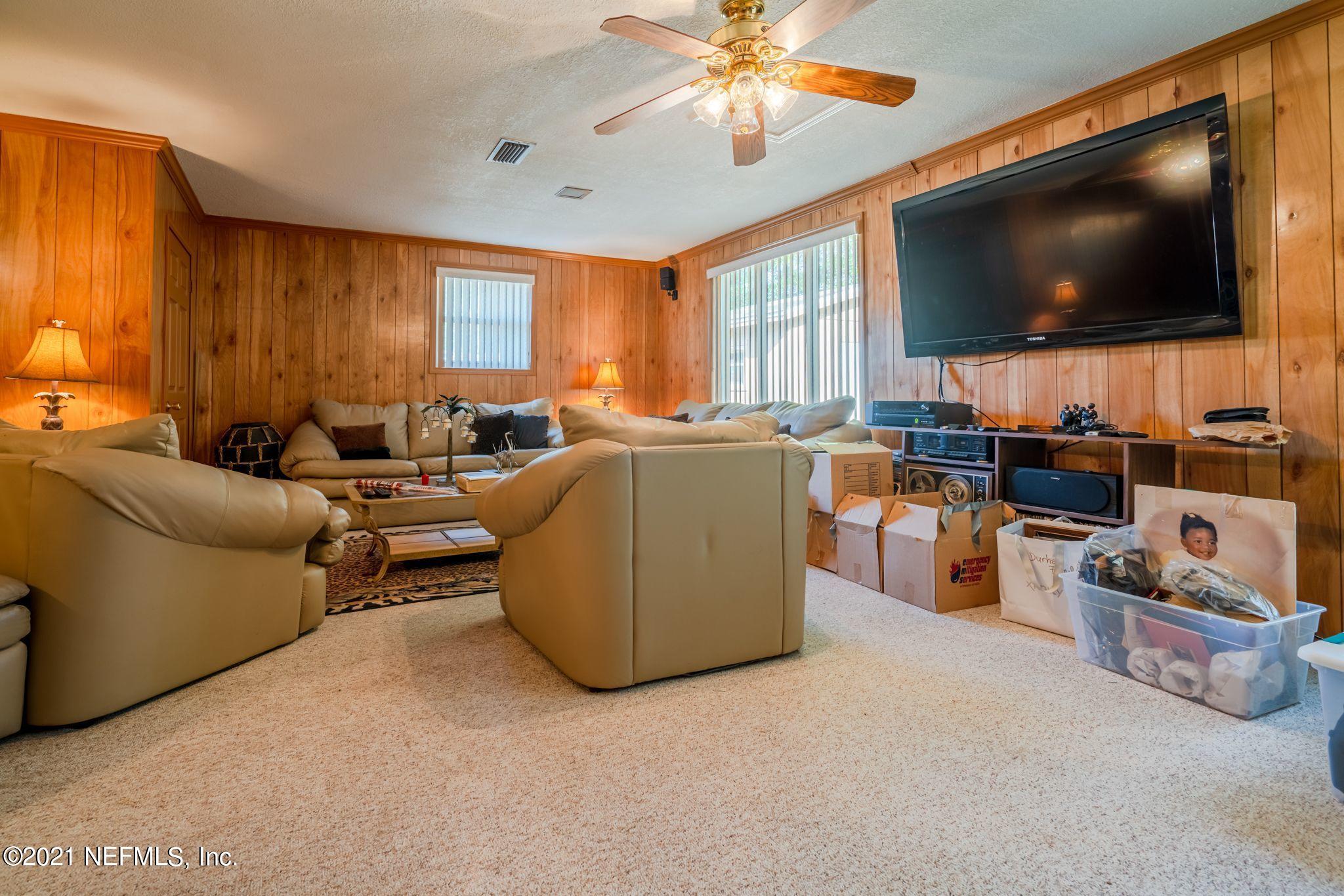 4612 Castleton Drive Jacksonville, FL 32208 - Photo 36 of 41 a living room with furniture and a flat screen tv