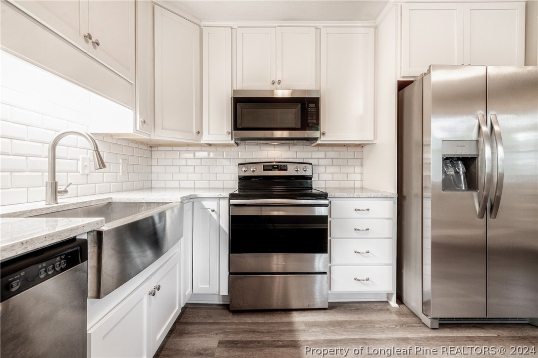 5851 Columbine Road Fayetteville, NC 28306 - Photo 13 of 25 a kitchen with granite countertop a stainless steel appliances a sink and cabinets