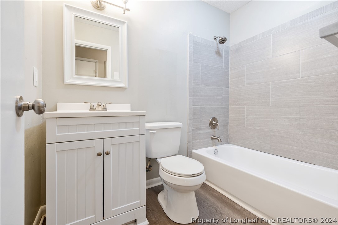 5851 Columbine Road Fayetteville, NC 28306 - Photo 16 of 25 a bathroom with a sink toilet and shower