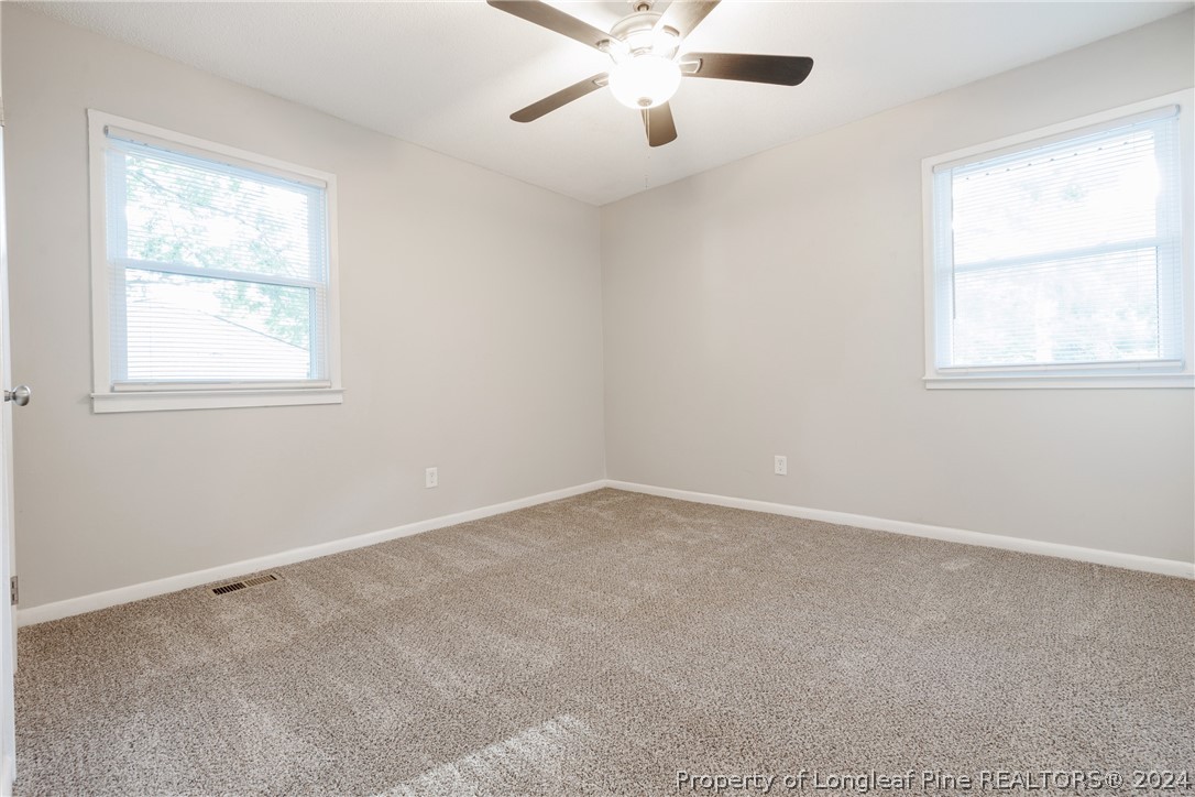 5851 Columbine Road Fayetteville, NC 28306 - Photo 19 of 25 an empty room with a window and a fan