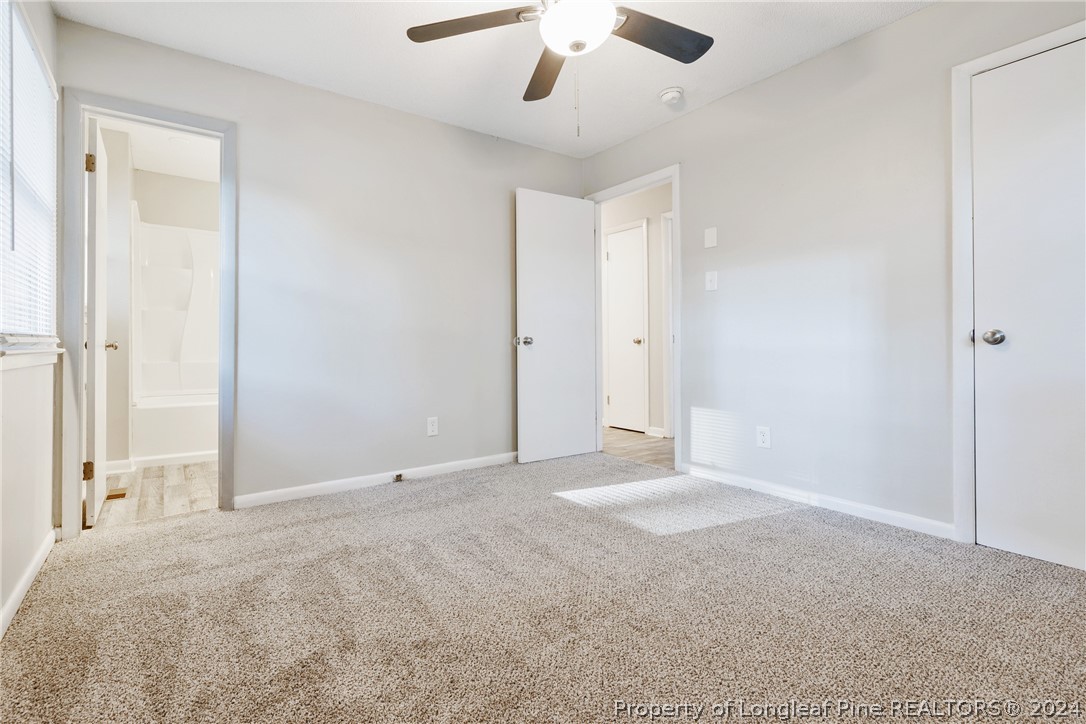 5851 Columbine Road Fayetteville, NC 28306 - Photo 20 of 25 a view of an empty room with a chandelier fan