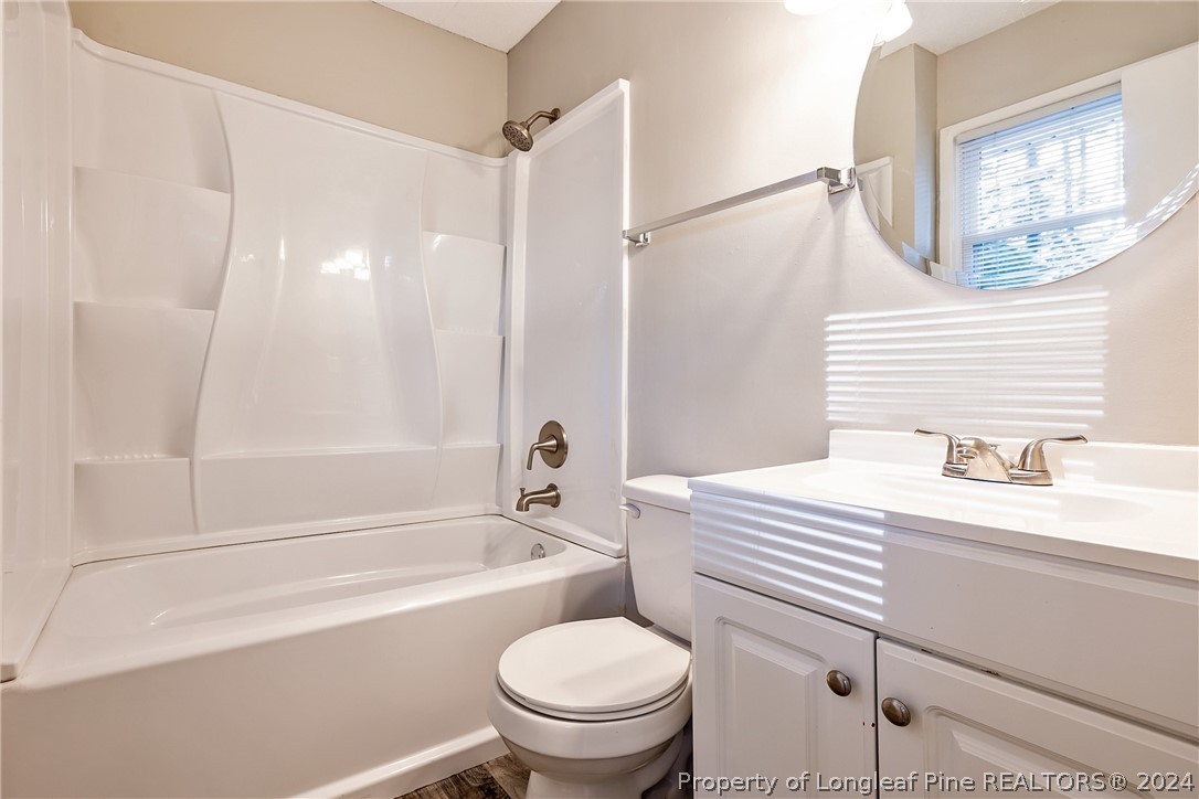 5851 Columbine Road Fayetteville, NC 28306 - Photo 21 of 25 a bathroom with a sink a toilet and a bathtub