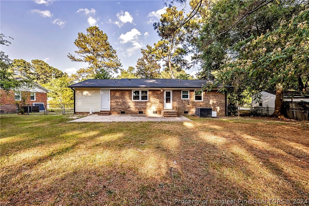 5851 Columbine Road Fayetteville, NC 28306 - Photo 24 of 25 a front view of a house with a yard and a garage