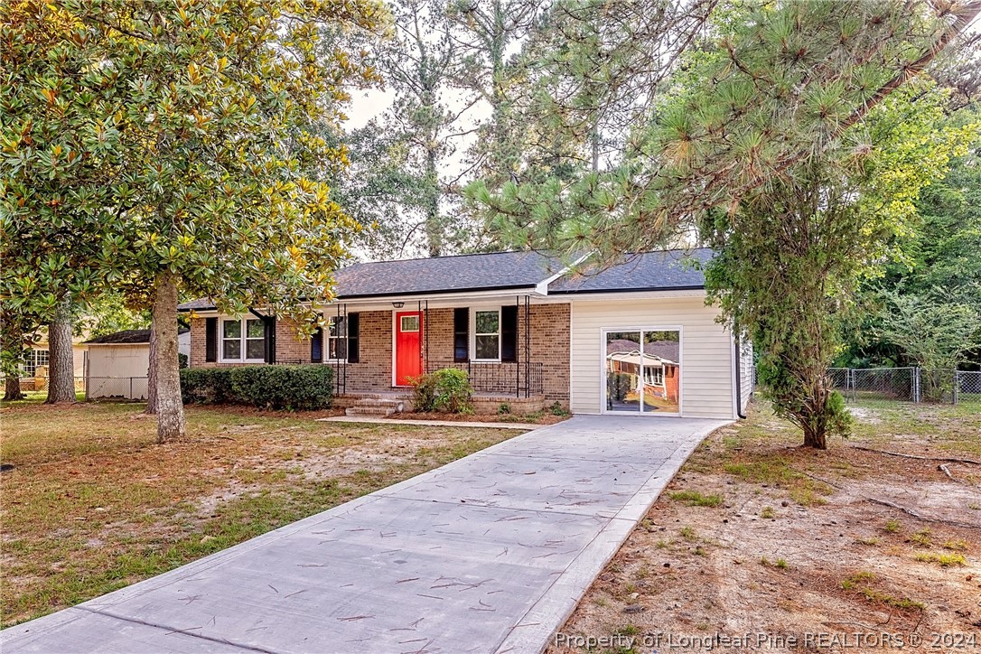 5851 Columbine Road Fayetteville, NC 28306 - Photo 3 of 25 a front view of a house with a yard and trees