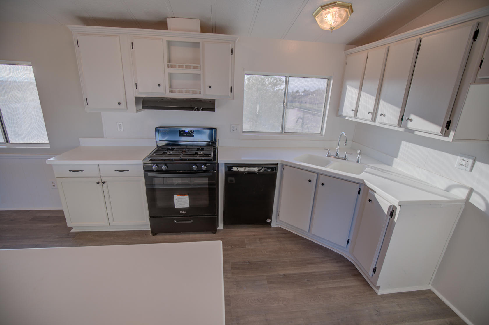 851 65th Street West Rosamond, CA 93560 - Photo 8 of 29 a kitchen with cabinets appliances and a sink