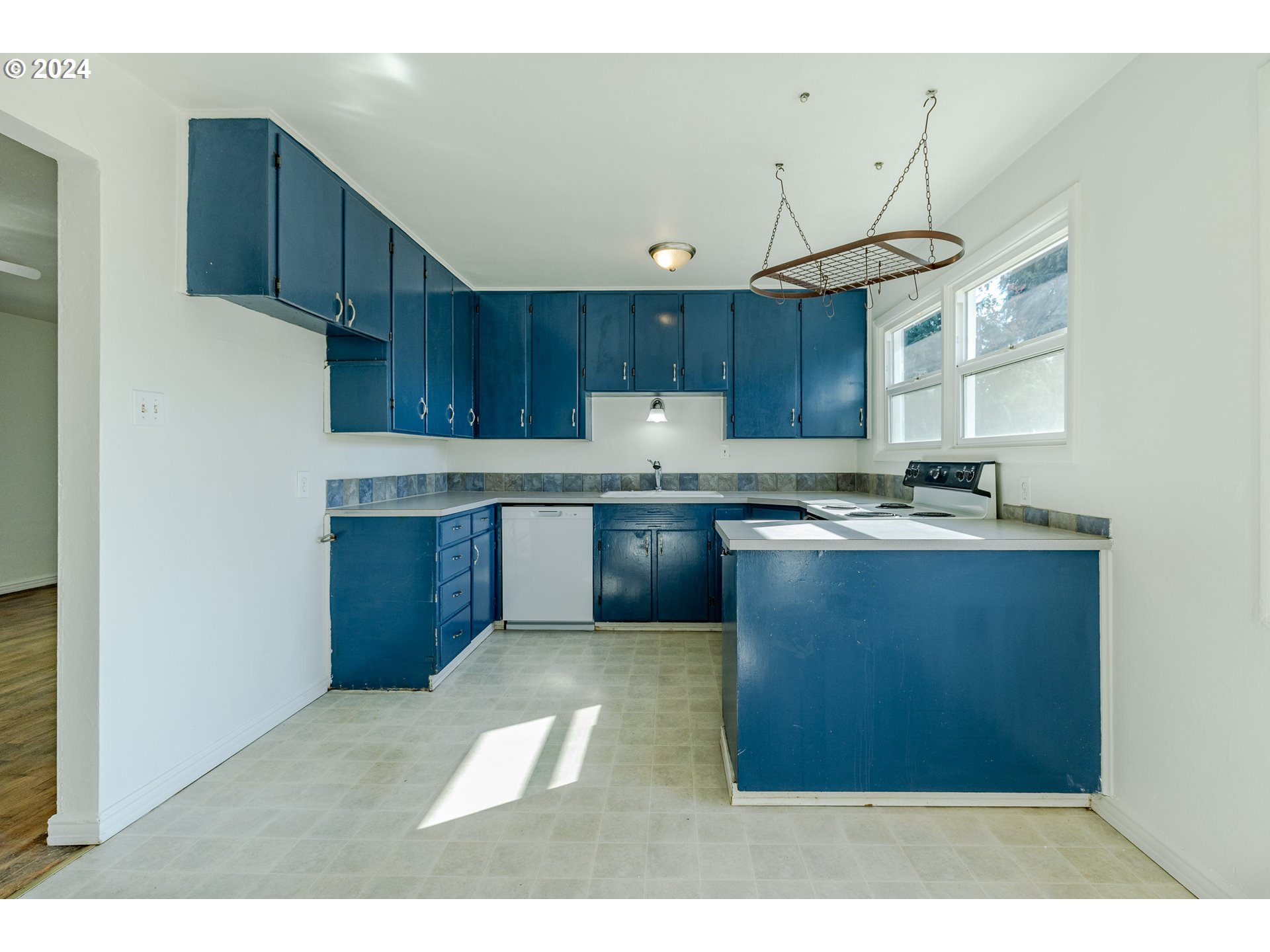 1393 M Street Springfield, OR 97477 - Photo 8 of 24 a kitchen with granite countertop a sink cabinets and stainless steel appliances