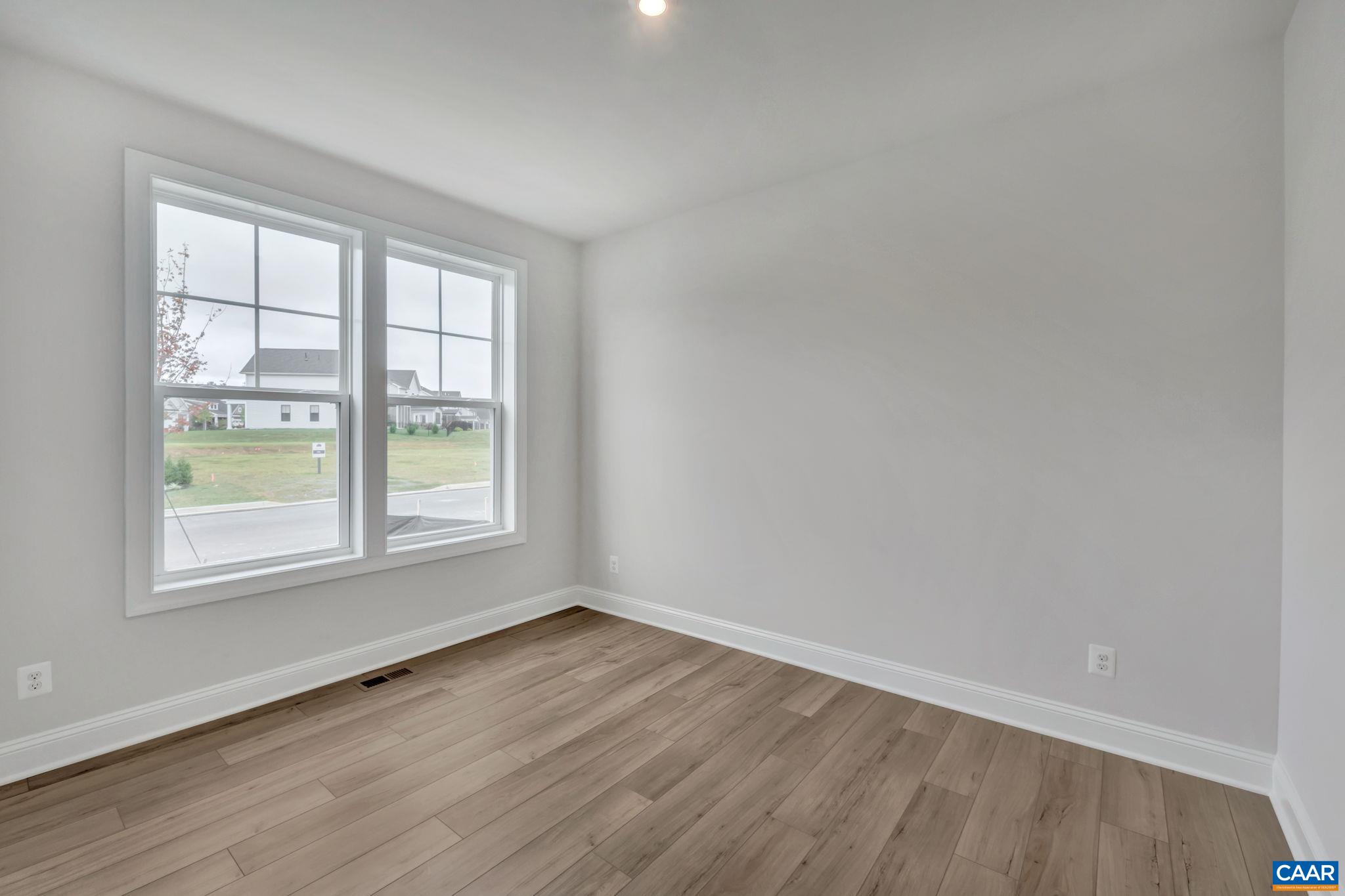1773 Fowler Street Charlottesville, VA 22901 - Photo 8 of 56 an empty room with wooden floor and windows