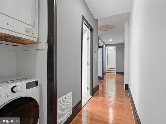 a view of a hallway with washer and dryer