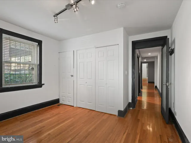 a view of a room with wooden floor and window