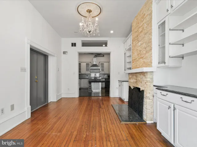 a large kitchen with cabinets wooden floor and stainless steel appliances