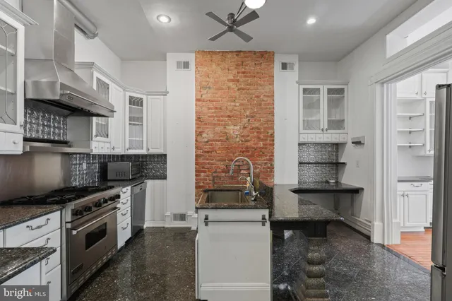a kitchen with a stove and a refrigerator