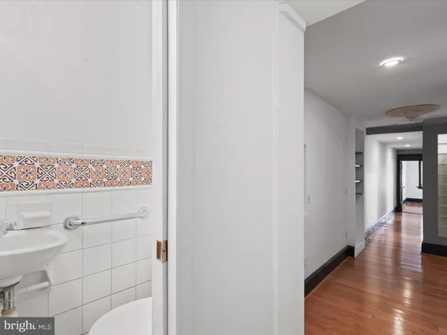 a view of hallway with wooden floor