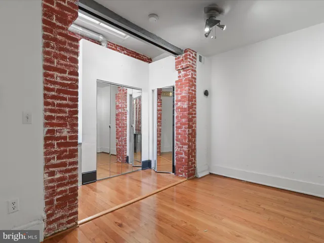 a view of a room with wooden floor and windows
