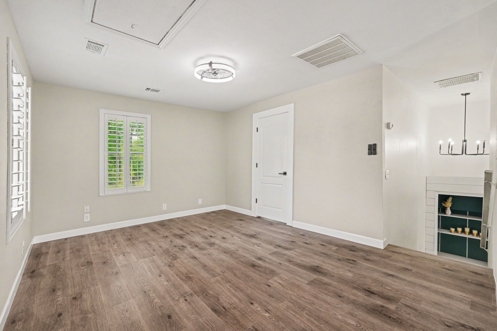 31730 Waller Tomball Road Waller, TX 77484 - Photo 32 of 50 The expansive 2nd floor game room impresses with luxury vinyl flooring, while built-in bookshelves at the stair landing add a touch of sophistication and charm.