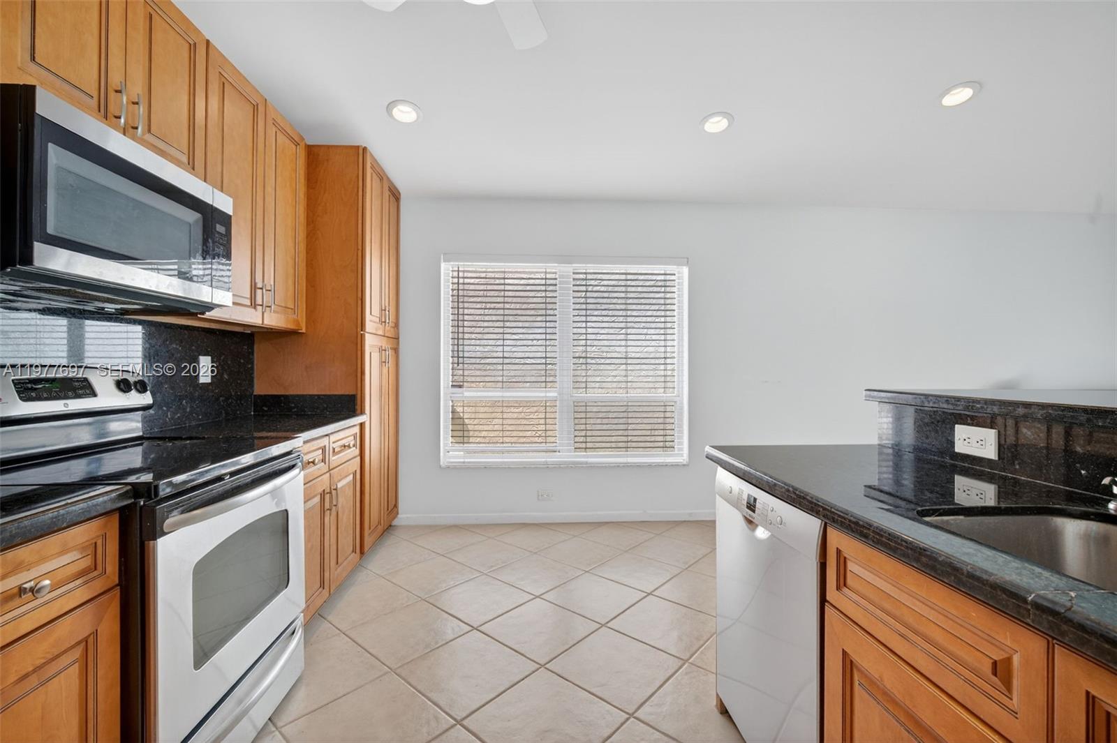 10624 Plainview Circle Boca Raton, FL 33498 - Photo 11 of 49 a kitchen with stainless steel appliances granite countertop a sink and a stove