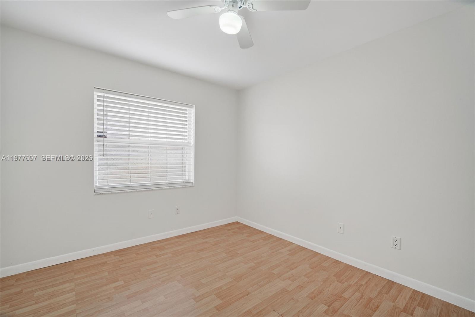 10624 Plainview Circle Boca Raton, FL 33498 - Photo 24 of 49 wooden floor in an empty room with a window