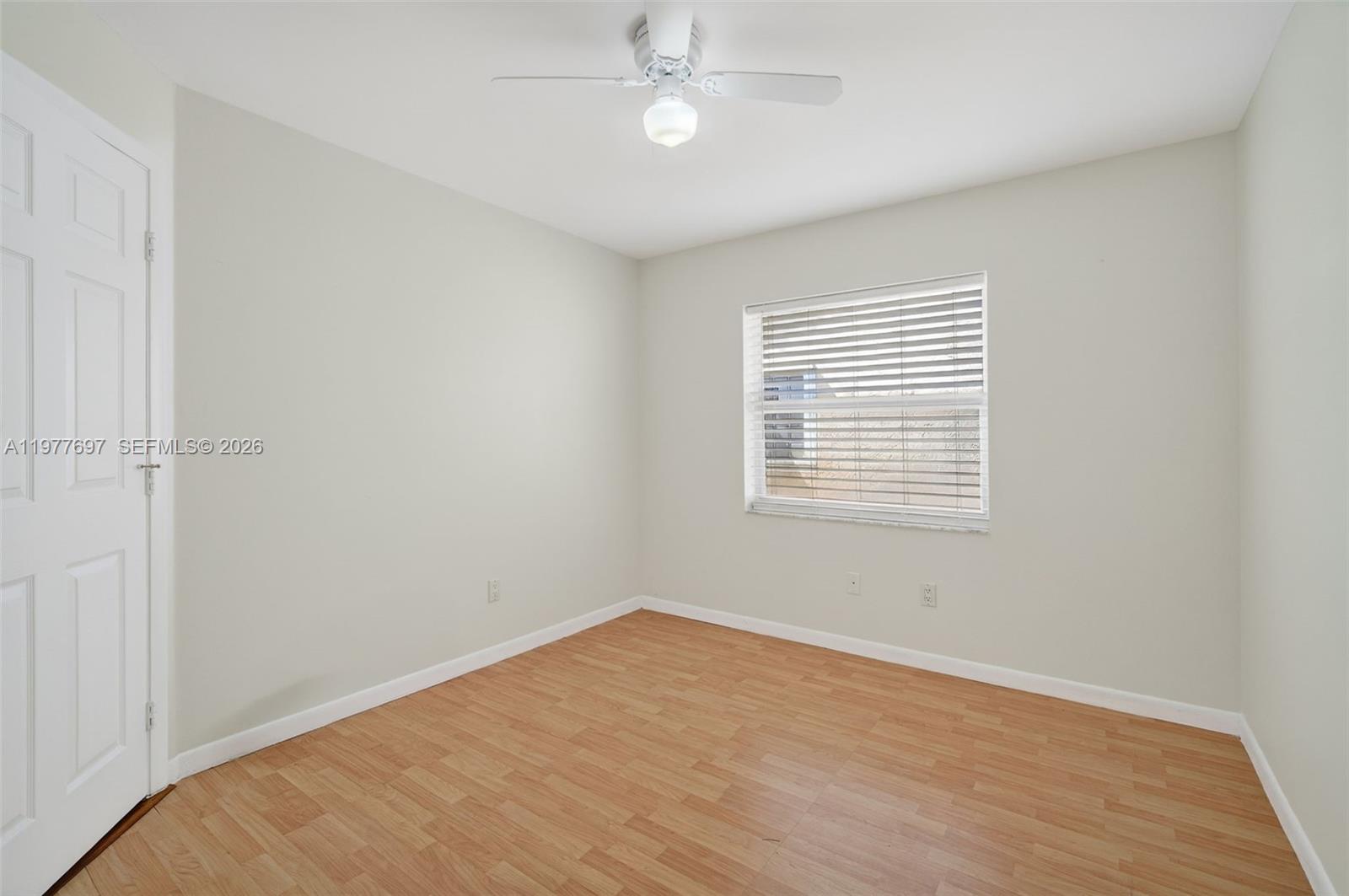 10624 Plainview Circle Boca Raton, FL 33498 - Photo 26 of 49 wooden floor in an empty room with a window