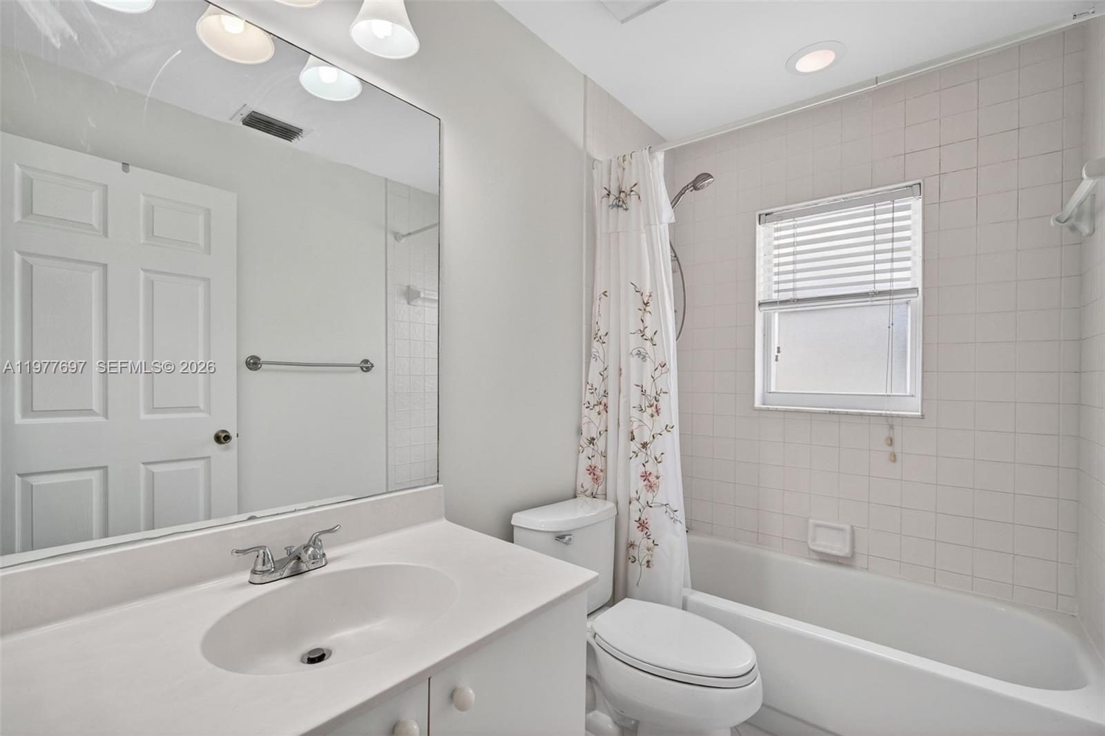 10624 Plainview Circle Boca Raton, FL 33498 - Photo 27 of 49 a bathroom with a sink a toilet and a mirror