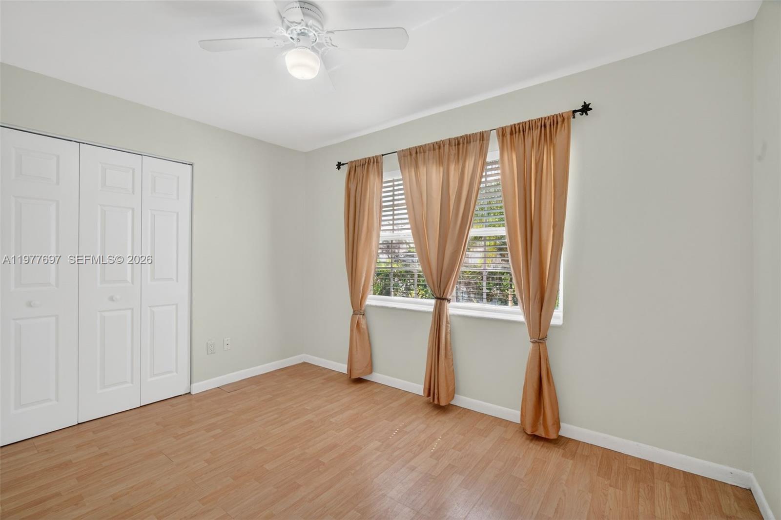 10624 Plainview Circle Boca Raton, FL 33498 - Photo 30 of 49 an empty room with wooden floor and windows