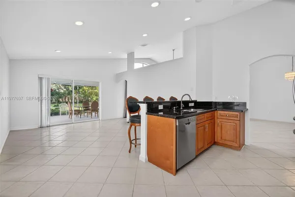 a kitchen with stainless steel appliances granite countertop a stove a sink and a refrigerator