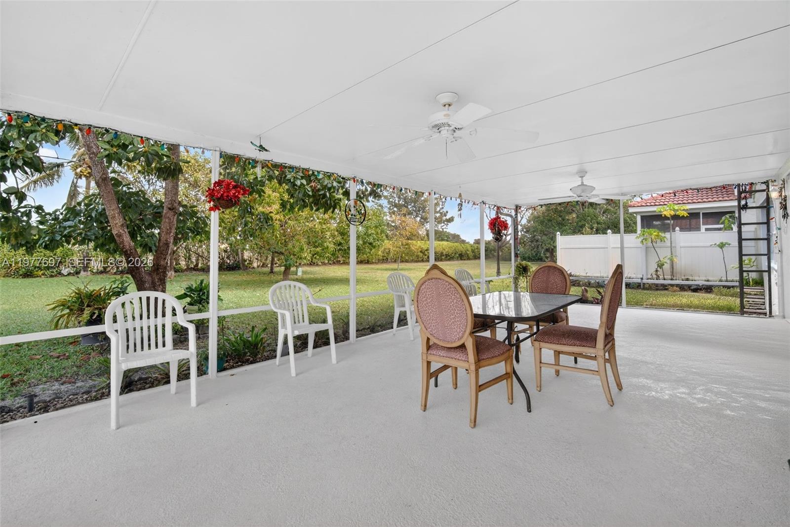10624 Plainview Circle Boca Raton, FL 33498 - Photo 32 of 49 a view of a patio with table and chairs potted plants and a large tree