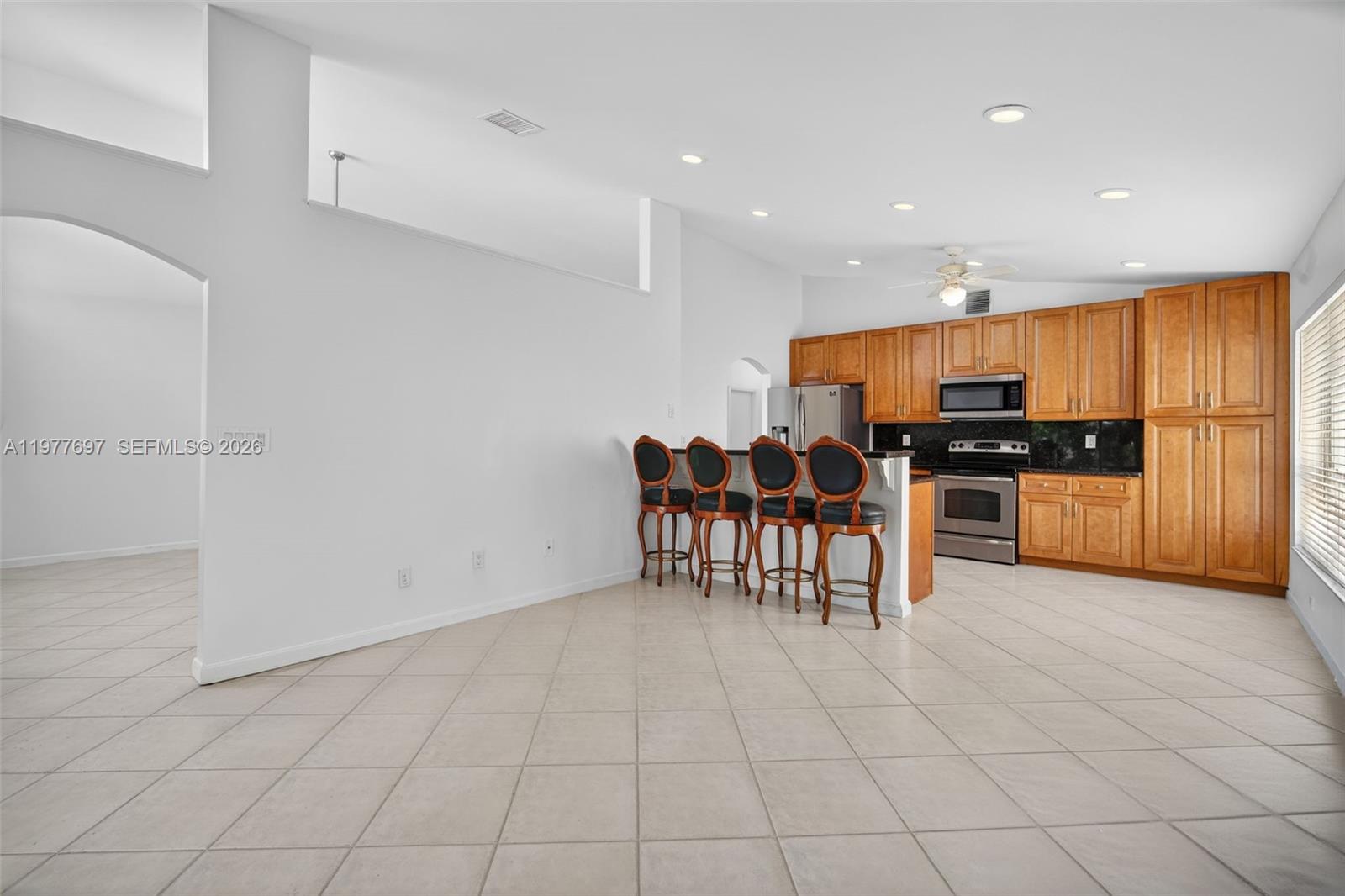 10624 Plainview Circle Boca Raton, FL 33498 - Photo 5 of 49 a kitchen with stainless steel appliances granite countertop a refrigerator and a stove top oven