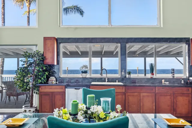 a front view of a house with a garden and patio