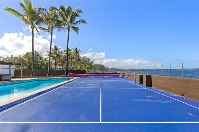 a view of a house with a yard and sitting area